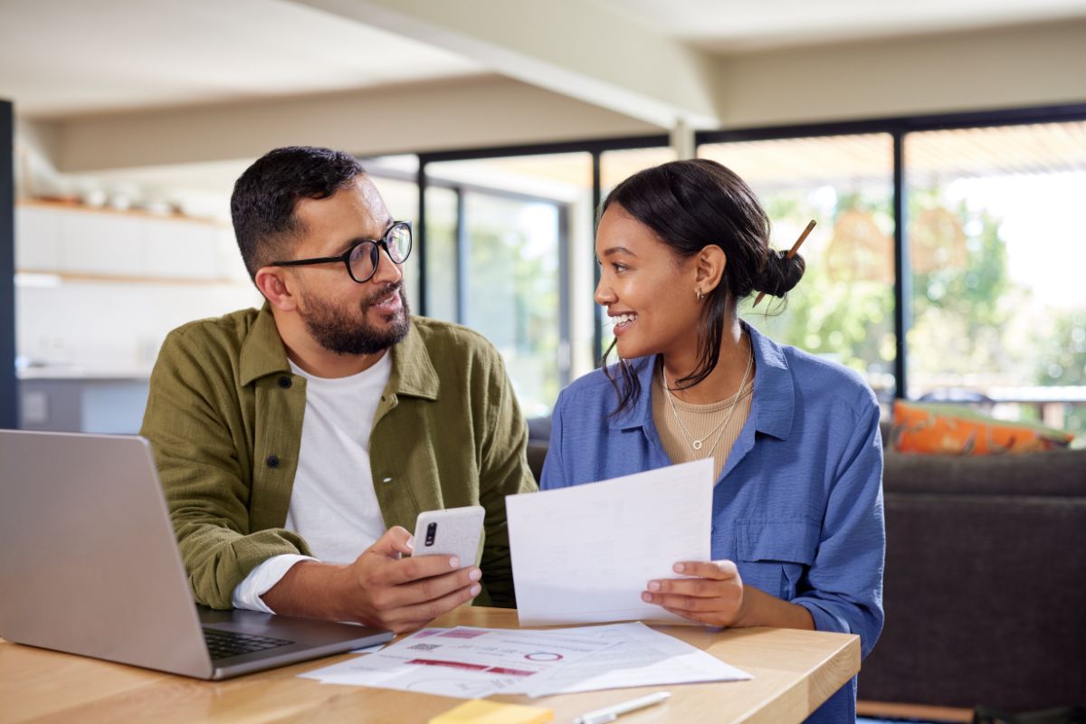 HonorHealth employee sits with partner at table discussing financial resources provided through HonorHealth employee benefits.