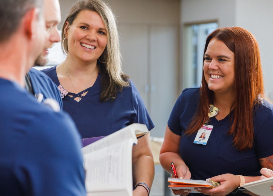 HonorHealth Culture & Community - Smiling employees gather around to talk.