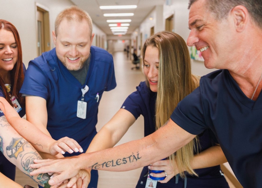 HonorHealth Careers - Smiling nursing employees huddle together for a team cheer.