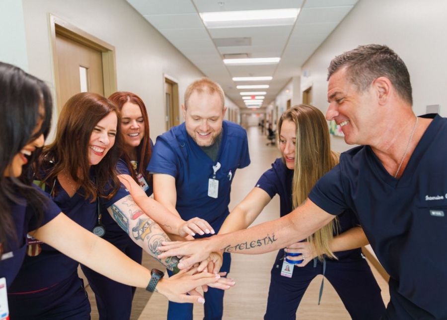 HonorHealth Careers - Smiling nursing employees huddle together for a team cheer.