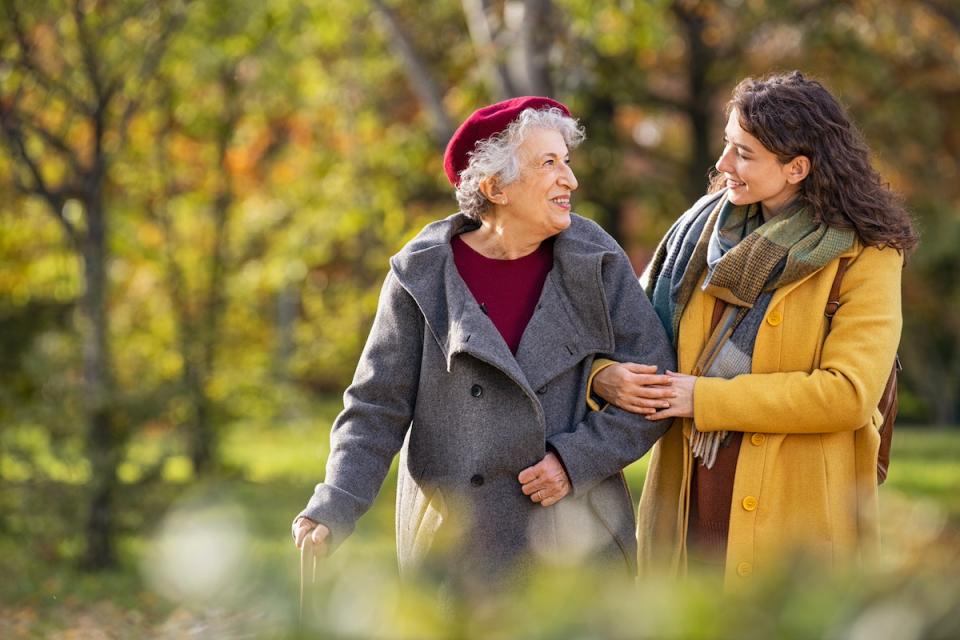 A patient walks with a family member