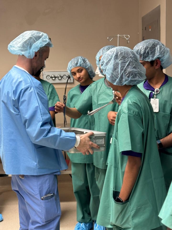 HonorHealth Medical Explorers Club teen volunteers work with physician in hands-on learning activity. 