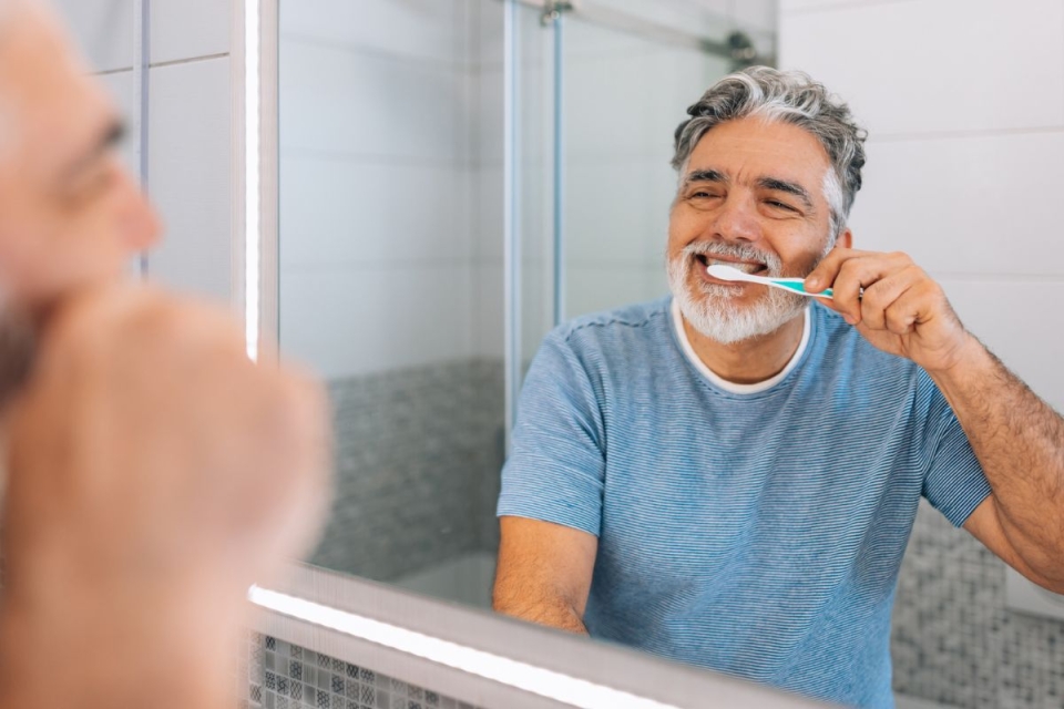HonorHealth Heart Care - Man brushes teeth to prevent heart disease