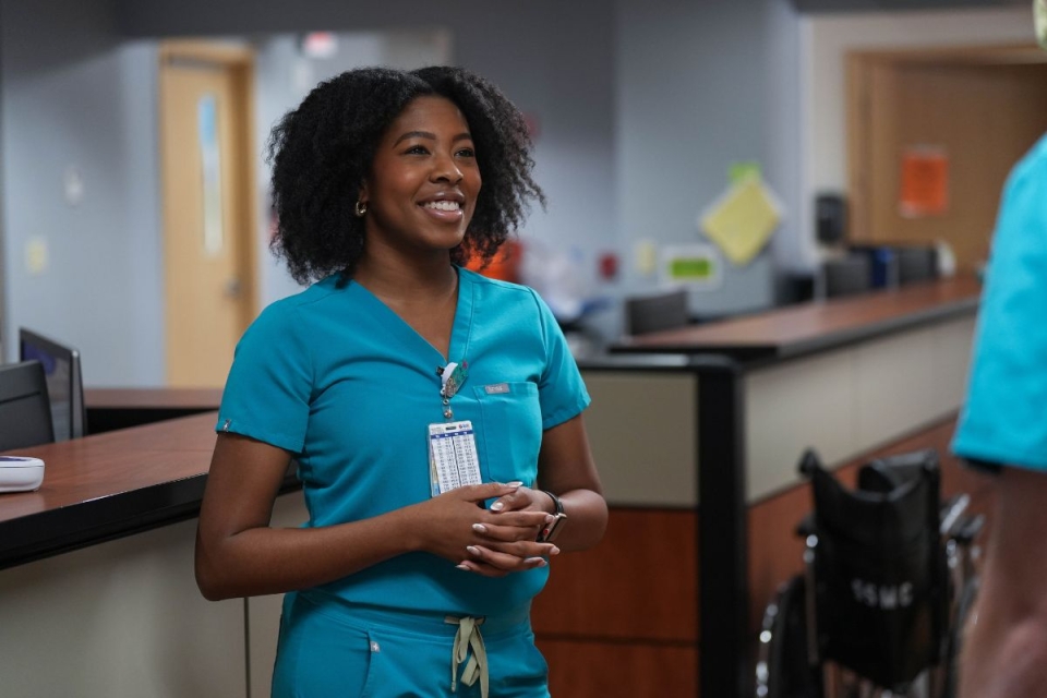 HonorHealth employee smiles during workday after making simple adjustments to protect her body from HonorHealth Occupational Medicine.