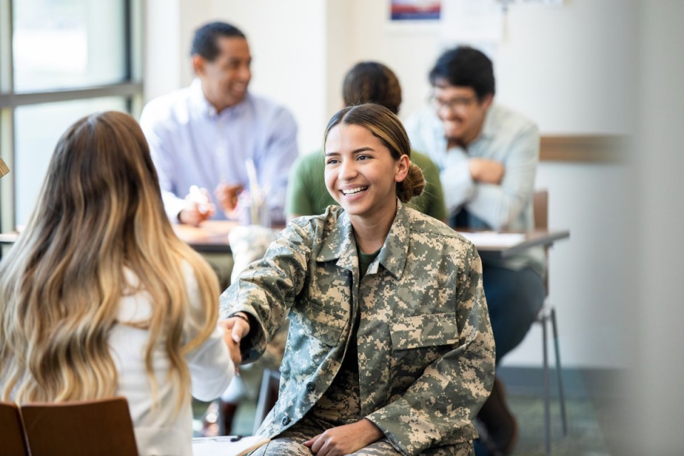 Female veteran reaches out for a handshake while meeting with HonorHealth, an Arizona Veteran Supportive Employer.