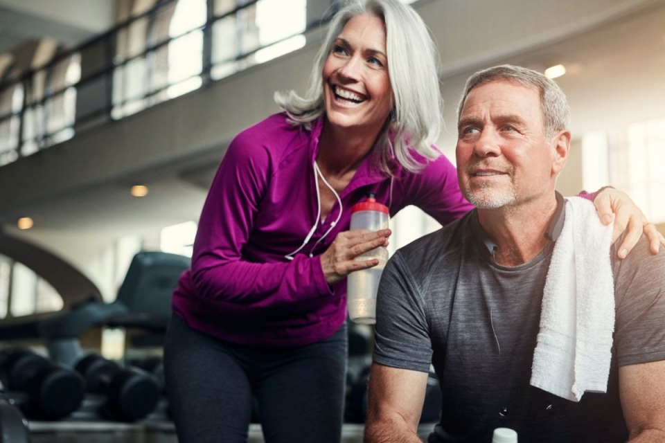 Smiling couple leans together during workout at HonorHealth Medical Fitness.