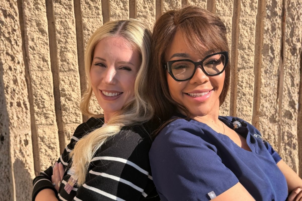 HonorHealth Careers - Nurses, Janae McVicker and Chastine Elam, pose back to back with smiles.