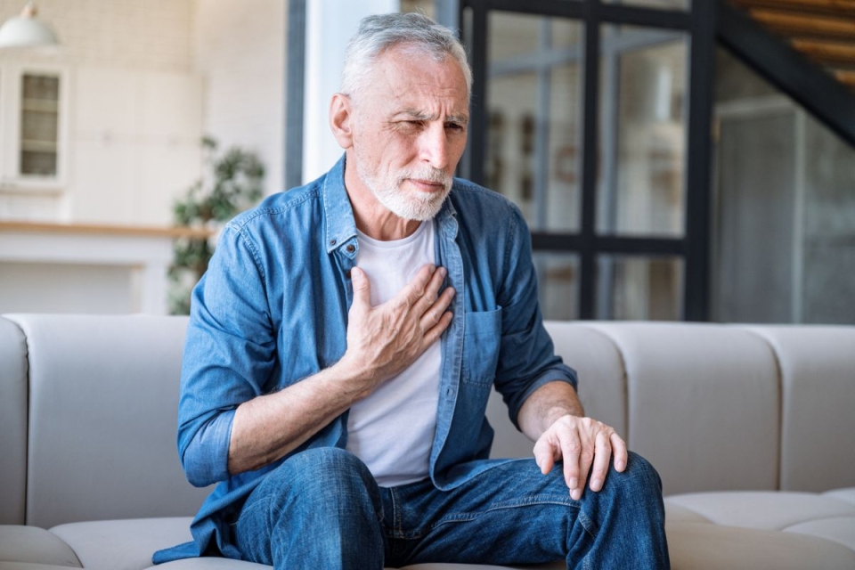 HonorHealth Heart Care - Man holds chest while experiencing arrhythmia due to stress.