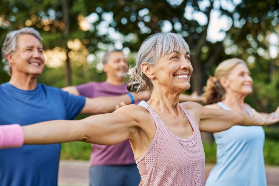 Smiling women of older age reduce their risk of stroke by exercising in the park.