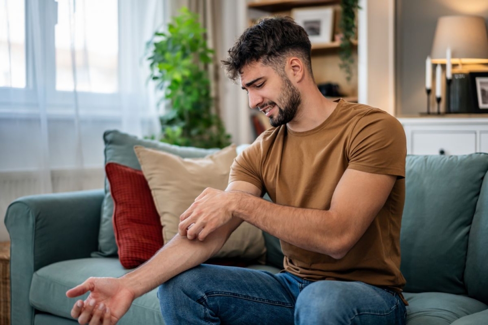 HonorHealth Primary Care - Man scratches mosquito bites during summertime in Arizona.