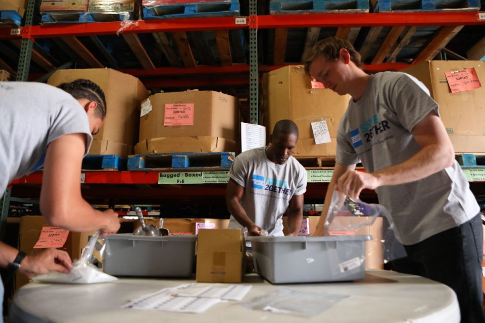 Group of volunteers package food at HonorHealth Desert Mission Food Bank.