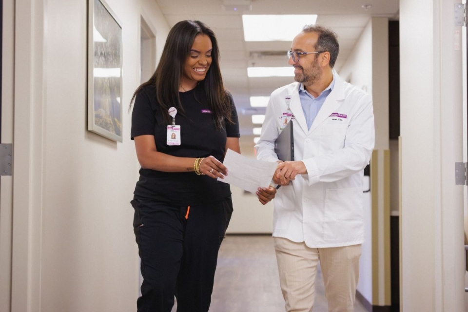 Two HonorHealth cardiology providers walk through East Mesa medical building.