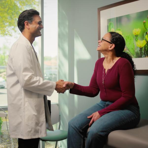 Laura shakes hands with Dr. Amar Thosani, marking a milestone in her weight loss journey and HonorHealth patient story.
