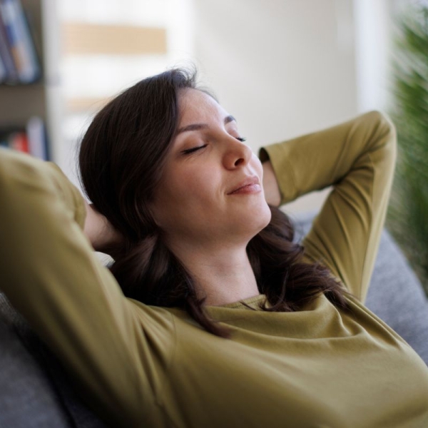 Woman smiles and relaxes on vacation after learning eight cold-busting travel habits from HonorHealth.