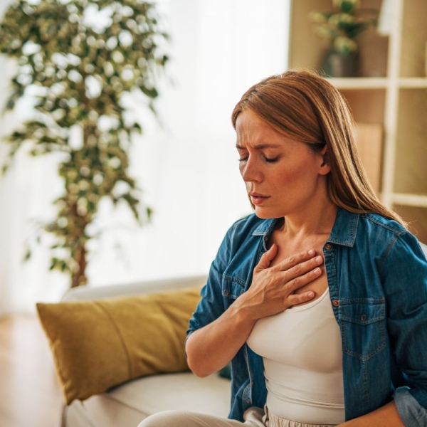 HonorHealth Heart Care - A woman experiences chest discomfort at home, a common yet often overlooked sign of heart attack in women.