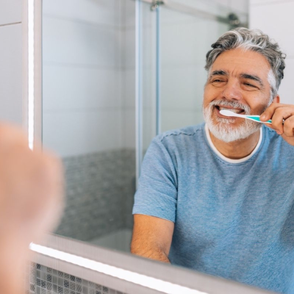 HonorHealth Heart Care - Man brushes teeth to prevent heart disease