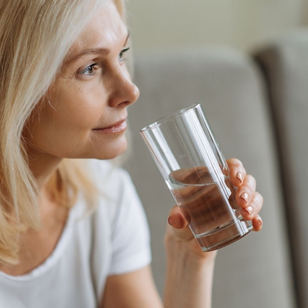 Woman over 45 years old drinks water in preparation for colonoscopy at HonorHealth.