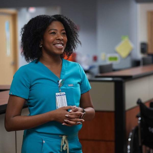 HonorHealth employee smiles during workday after making simple adjustments to protect her body from HonorHealth Occupational Medicine.
