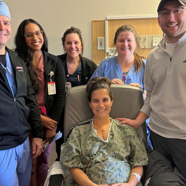 Pregnant patient, her partner and HonorHealth staff smile during a group photo after lifesaving treatment for a dangerous heart infection.