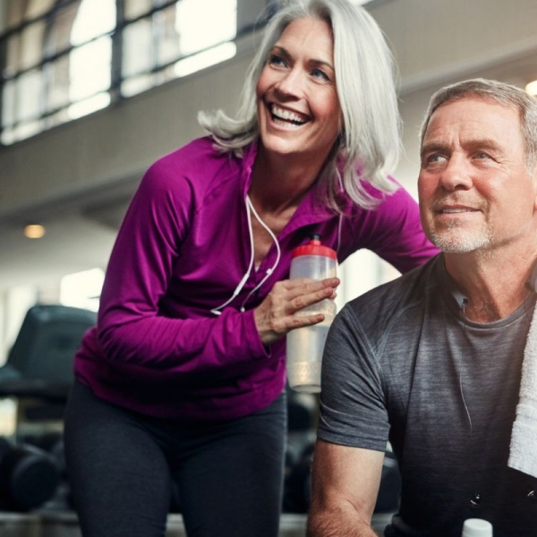 Smiling couple leans together during workout at HonorHealth Medical Fitness.