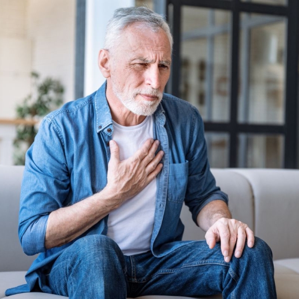 HonorHealth Heart Care - Man holds chest while experiencing arrhythmia due to stress.