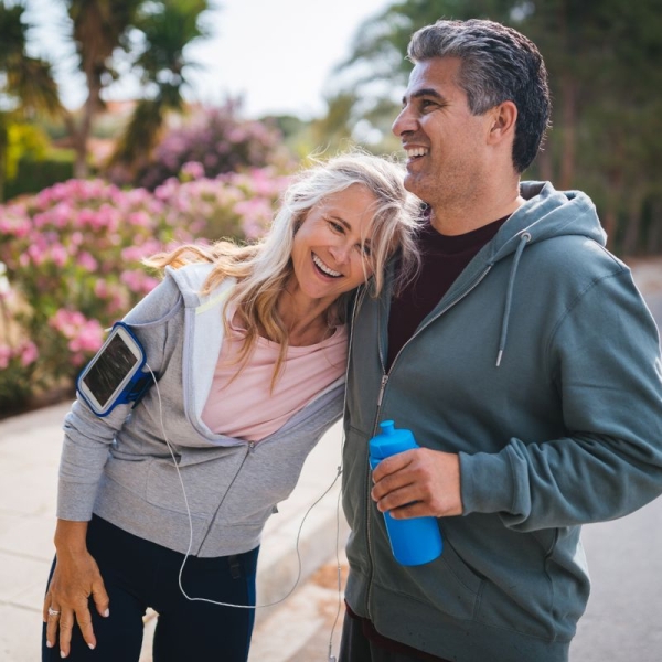 HonorHealth Concierge Neurology - Couple smiles while taking a break during an outdoor run.