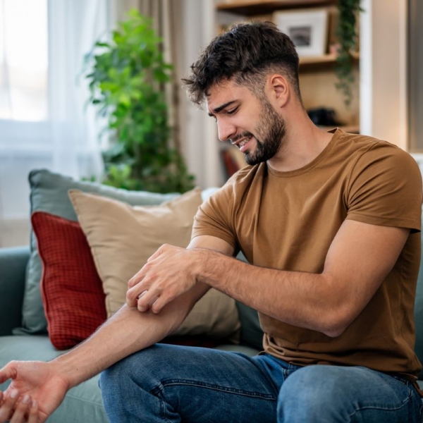 HonorHealth Primary Care - Man scratches mosquito bites during summertime in Arizona.