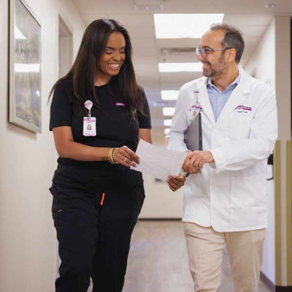 Two HonorHealth cardiology providers walk through East Mesa medical building.