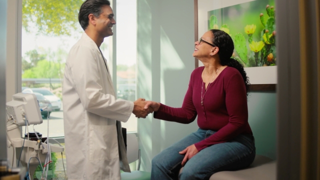 Laura shakes hands with Dr. Amar Thosani, marking a milestone in her weight loss journey and HonorHealth patient story.