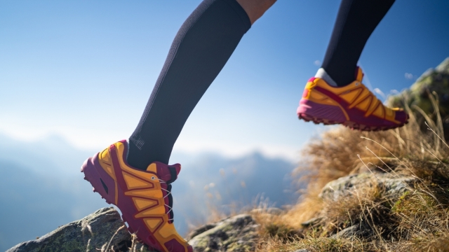 HonorHealth Vein Program - Hiker runs up rocky hill in compression socks for optimal vein health.