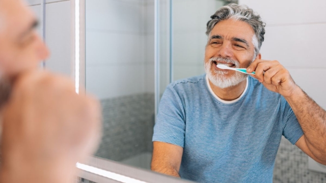 HonorHealth Heart Care - Man brushes teeth to prevent heart disease