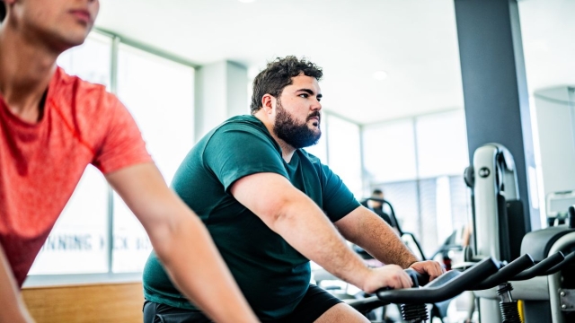 HonorHealth Weight Loss and Bariatrics - Male patient exercises on stationary bike as a part of his HonorHealth weight loss plan.