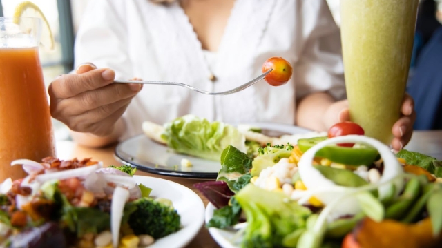 HonorHealth Executive Health - Woman uses "fibermaxxing" trend to get healthier, showing table of healthy, fiber-filled foods.