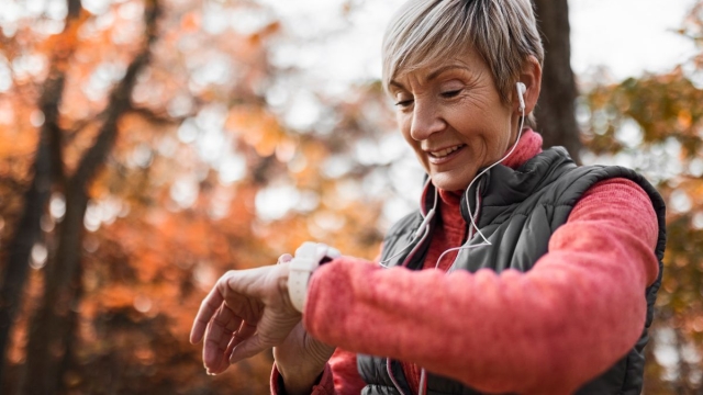 HonorHealth Heart Care - Woman monitors heart health with Apple Watch on jog outside.