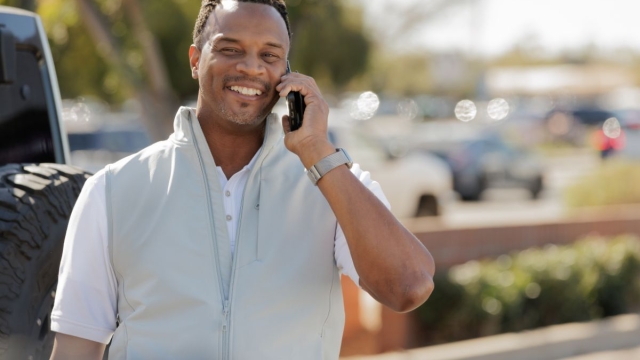 HonorHealth Executive Health - Man smiles while talking on the phone, as his care at HonorHealth is built entirely around his busy schedule.