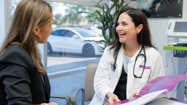 HonorHealth Executive Health - Physician smiles while conversing with patient.