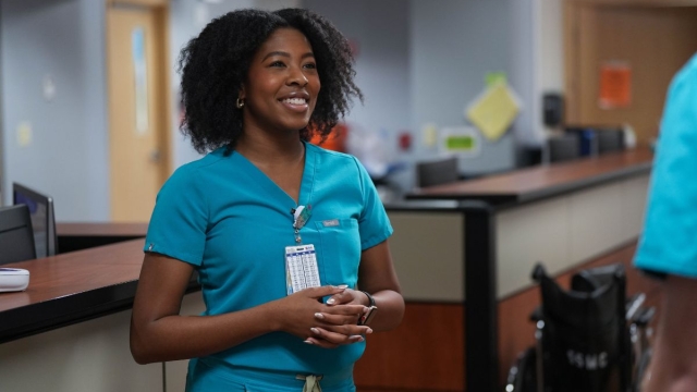 HonorHealth employee smiles during workday after making simple adjustments to protect her body from HonorHealth Occupational Medicine.
