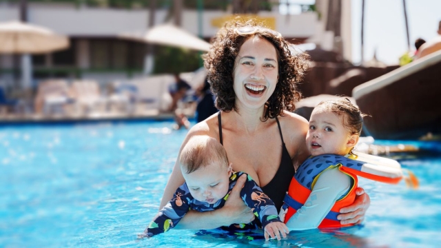 HonorHealth Primary Care - Mother and two young children safely enjoy hot Arizona summer in pool after using HonorHealth Arizona summer safety tips.