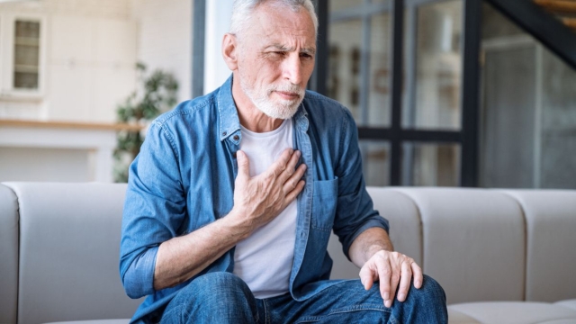 HonorHealth Heart Care - Man holds chest while experiencing arrhythmia due to stress.