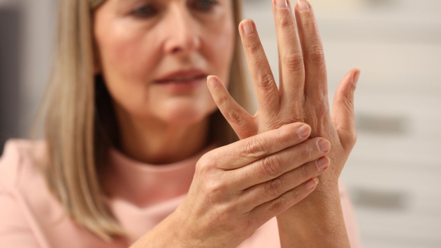 HonorHealth General Surgery - Woman holds aching hand with arthritis caused by GLP-1 weight loss drug.