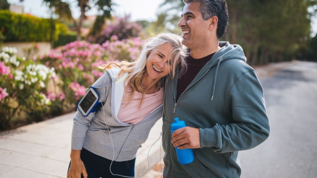 HonorHealth Concierge Neurology - Couple smiles while taking a break during an outdoor run.