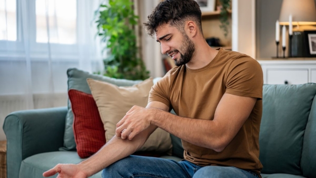 HonorHealth Primary Care - Man scratches mosquito bites during summertime in Arizona.