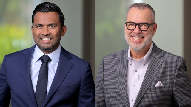 Side-by-side professional headshots of Dr. Ajit Itty on the left in a navy suit and tie, and Dr. Kevan Pickrel on the right in glasses and a grey plaid suit jacket.