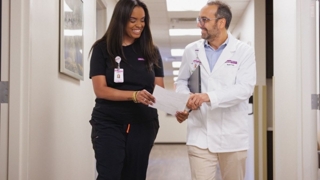 Two HonorHealth cardiology providers walk through East Mesa medical building.