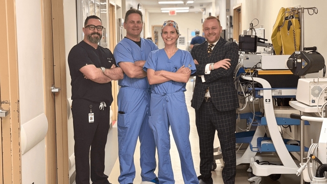 Four members of the HonorHealth Mitral Valve Therapy team standing in a hospital hallway.
