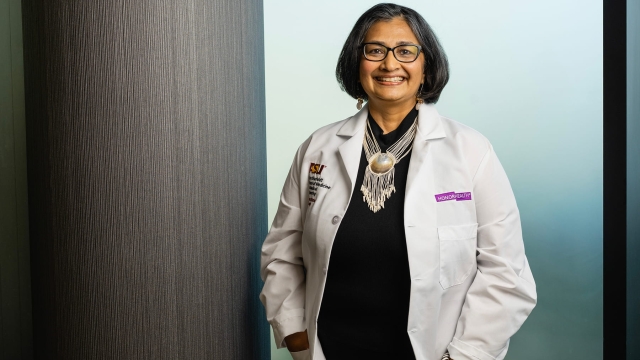 Priya Radhakrishnan, MD, HonorHealth chief academic officer, smiling in a white lab coat.